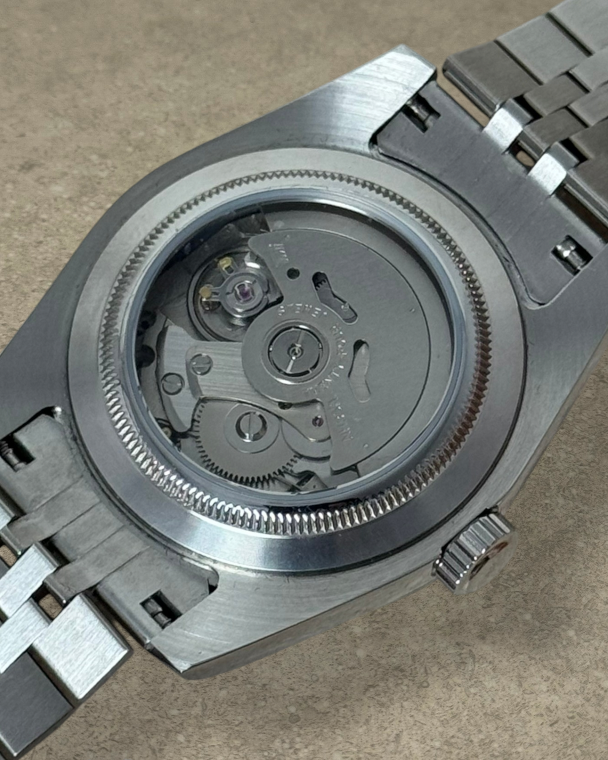 PB TimePiece Classic Date watch showing the automatic Seiko NH35 movement through the stainless steel exhibition case