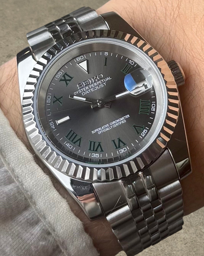 PB TimePiece Classic Date Wimbledon watch with gray dial, green Roman numerals, and stainless steel jubilee bracelet