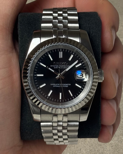 PB TimePiece Classic Date watch with a jet black dial, fluted bezel, and stainless steel jubilee bracelet.