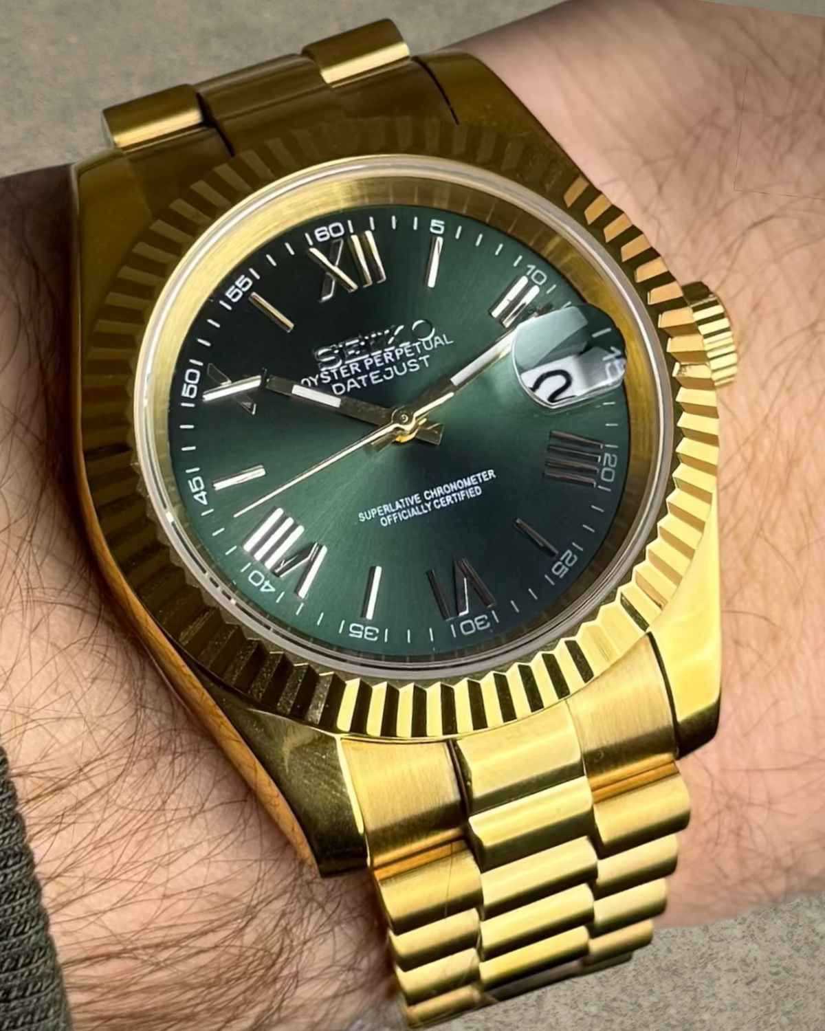PB TimePiece Classic Date watch with an olive green dial, gold stainless steel case, and presidential bracelet.