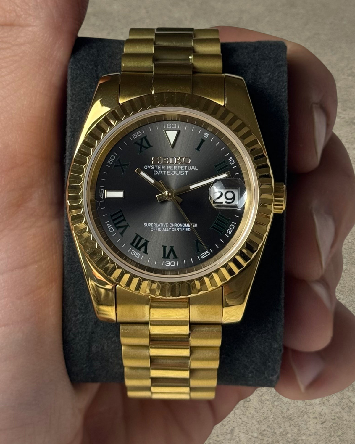 PB TimePiece gold stainless steel automatic watch with a Wimbledon dial, fluted bezel, and presidential bracelet.