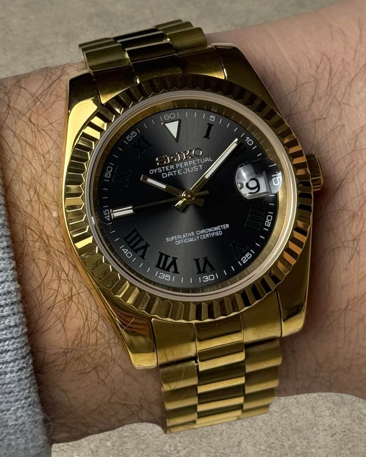 PB TimePiece Classic Date gold stainless steel watch with a black Wimbledon dial, fluted bezel, and presidential band.