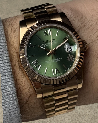 PB TimePiece Classic Date watch with an olive green dial, rose gold stainless steel case, fluted bezel, and bracelet.