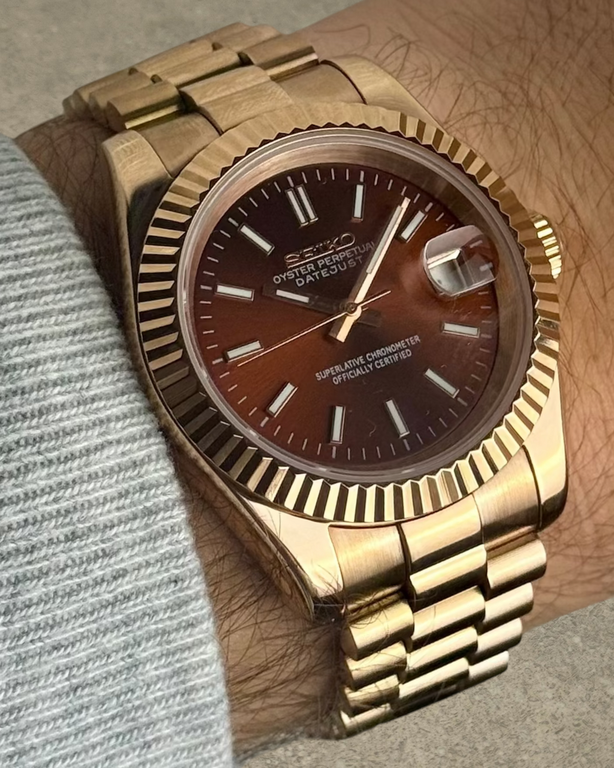 PB TimePiece Classic Date watch with a rose gold stainless steel case, fluted bezel, and chocolate dial on wrist.