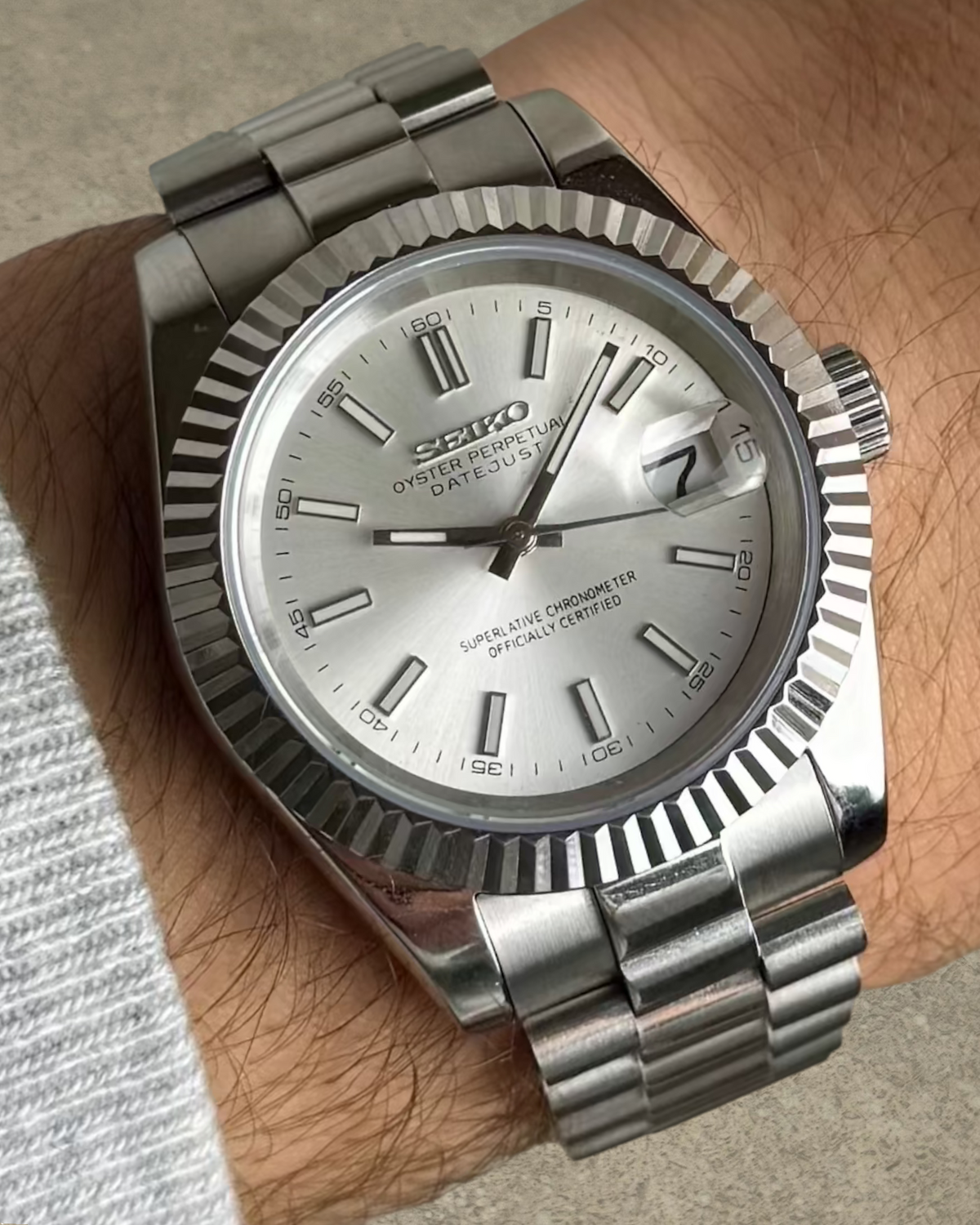 PB TimePiece Classic Date watch with silver dial, fluted bezel, and stainless steel presidential bracelet on wrist
