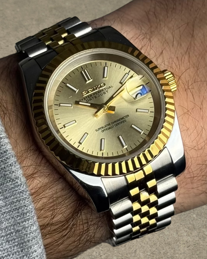 PB TimePiece Classic Date watch with two-tone gold and steel jubilee bracelet, champagne dial, and fluted bezel.