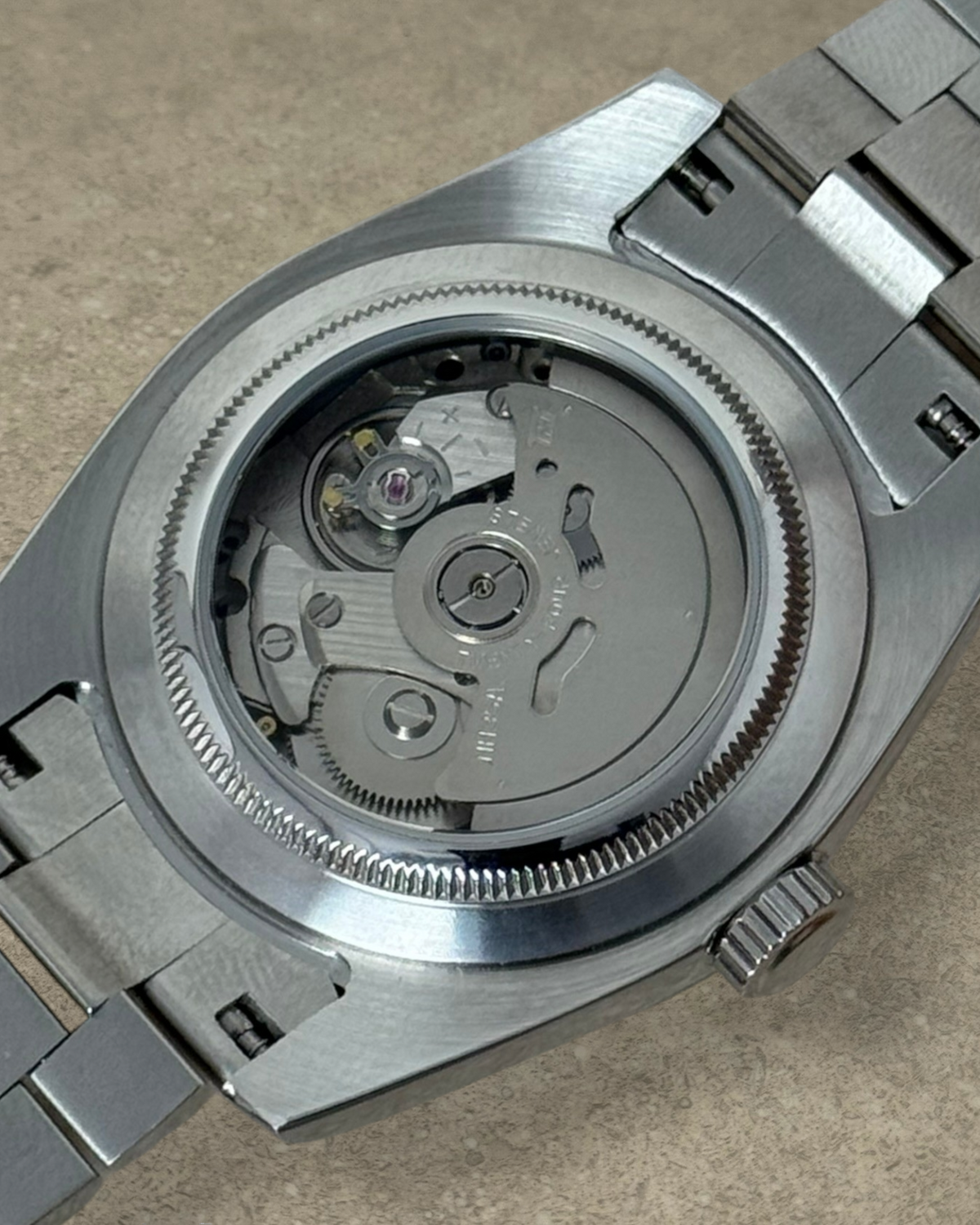 PB TimePiece Classic Date watch showing the automatic Seiko NH35 movement through the stainless steel exhibition case