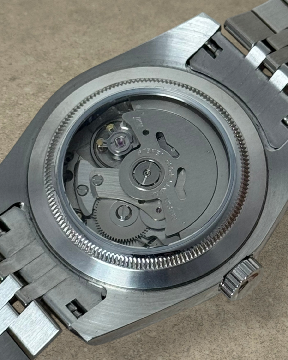 PB TimePiece Classic Date watch showing the exhibition case back with an automatic Seiko NH35 movement and bracelet