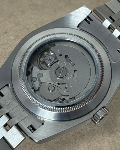 PB TimePiece Classic Date watch showing the exhibition case back with an automatic Seiko NH35 movement and bracelet