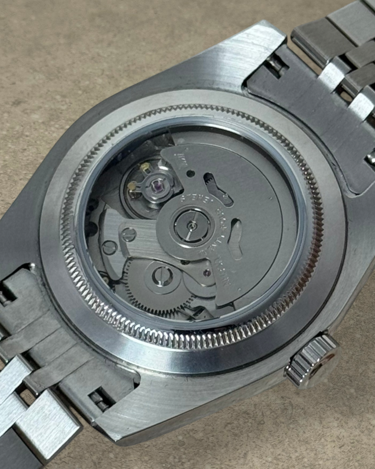 PB TimePiece Classic Date watch showing the exhibition case back with automatic Seiko NH35 movement and steel bracelet