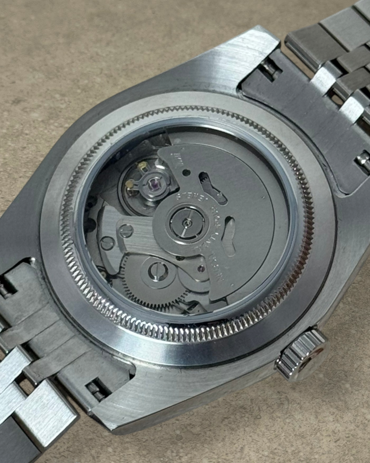 PB TimePiece Classic Date watch showing the exhibition case back with automatic Seiko NH35 movement and steel bracelet