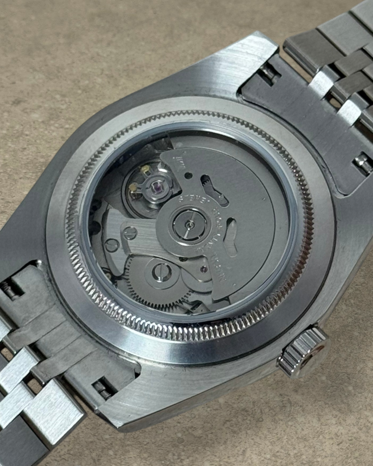 PB TimePiece automatic watch showing the exhibition case back with Seiko NH35 movement and stainless steel bracelet