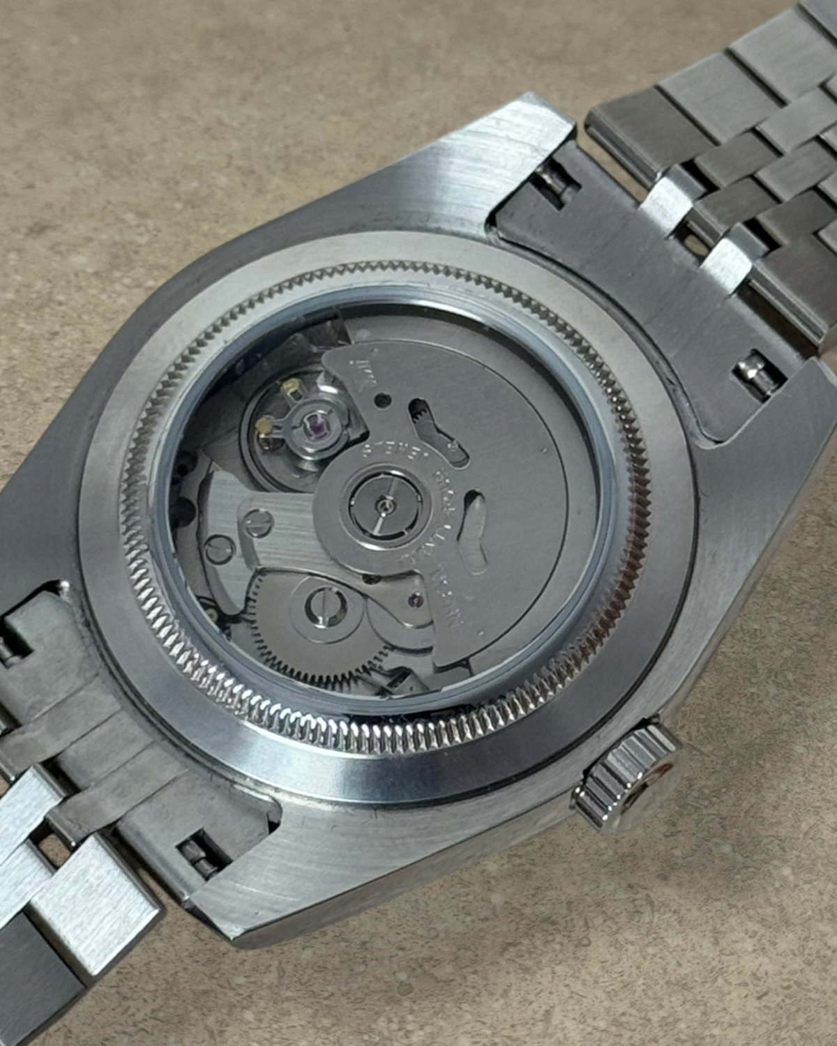 PB TimePiece Classic Date watch showing the stainless steel exhibition case back and automatic movement