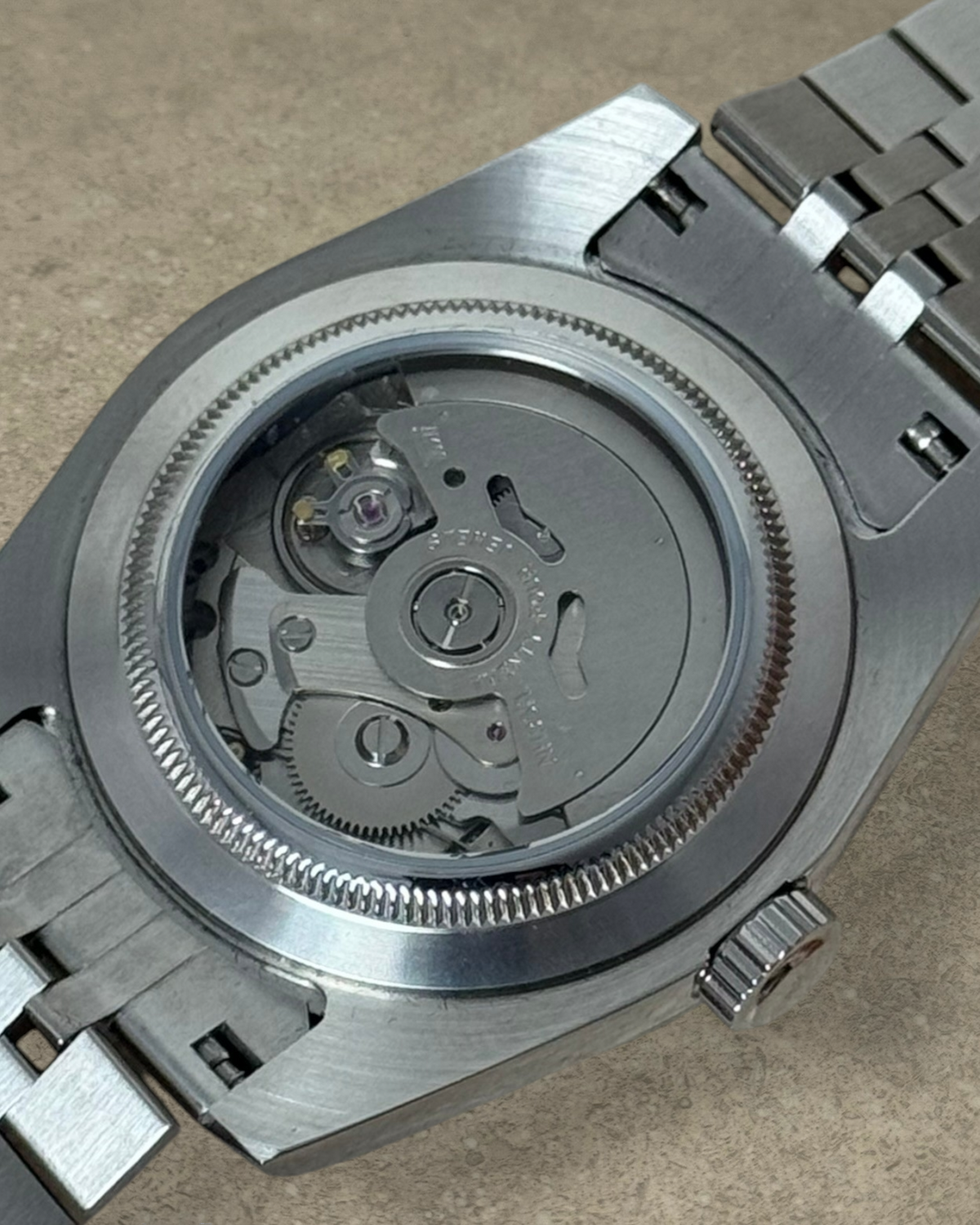 PB TimePiece Classic Date watch showing the stainless steel case back and automatic Seiko NH35 movement