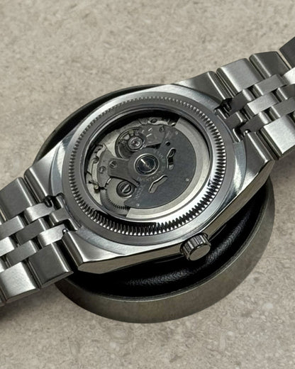 PB TimePiece Honeycomb watch showing the automatic Seiko NH35 movement through the stainless steel exhibition caseback