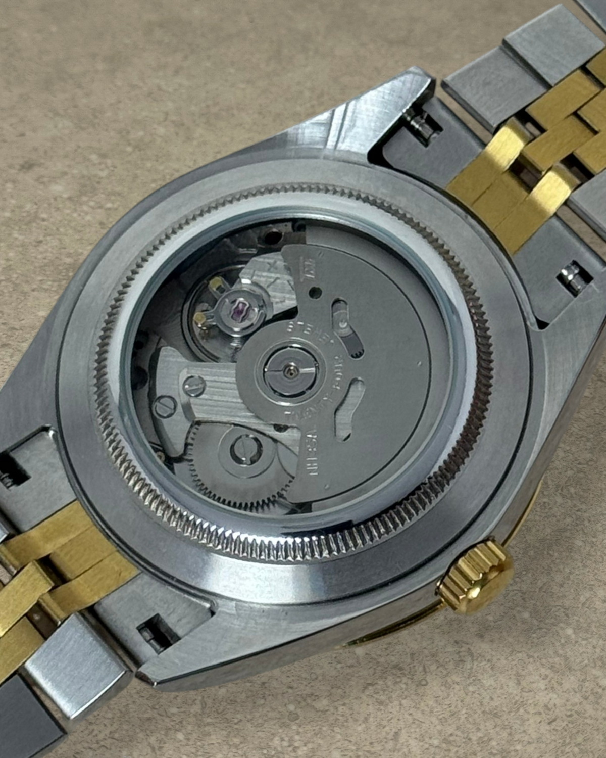 PB TimePiece Classic Date watch showing the automatic Seiko NH35 movement through a clear exhibition case back
