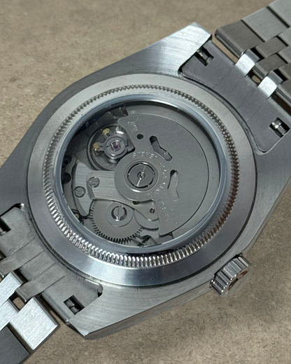 PB TimePiece Classic Date watch showing the stainless steel case back and automatic Seiko NH35 movement
