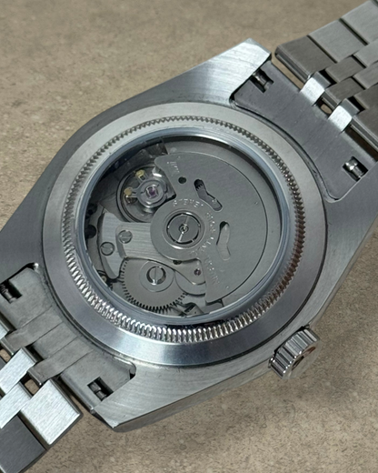 PB TimePiece Classic Date watch showing the stainless steel case back and automatic Seiko NH35 movement