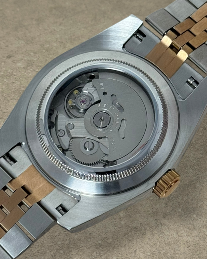PB TimePiece Classic Date watch showing the automatic Seiko NH35 movement through the stainless steel exhibition case