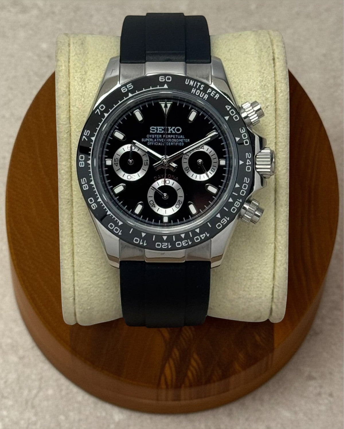 PB TimePiece chronograph watch with a 39mm stainless steel case, black dial, and black rubber strap on a display stand