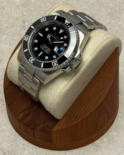 PB TimePiece Submariner watch with a black dial, rotating bezel, and brushed stainless steel oyster bracelet.