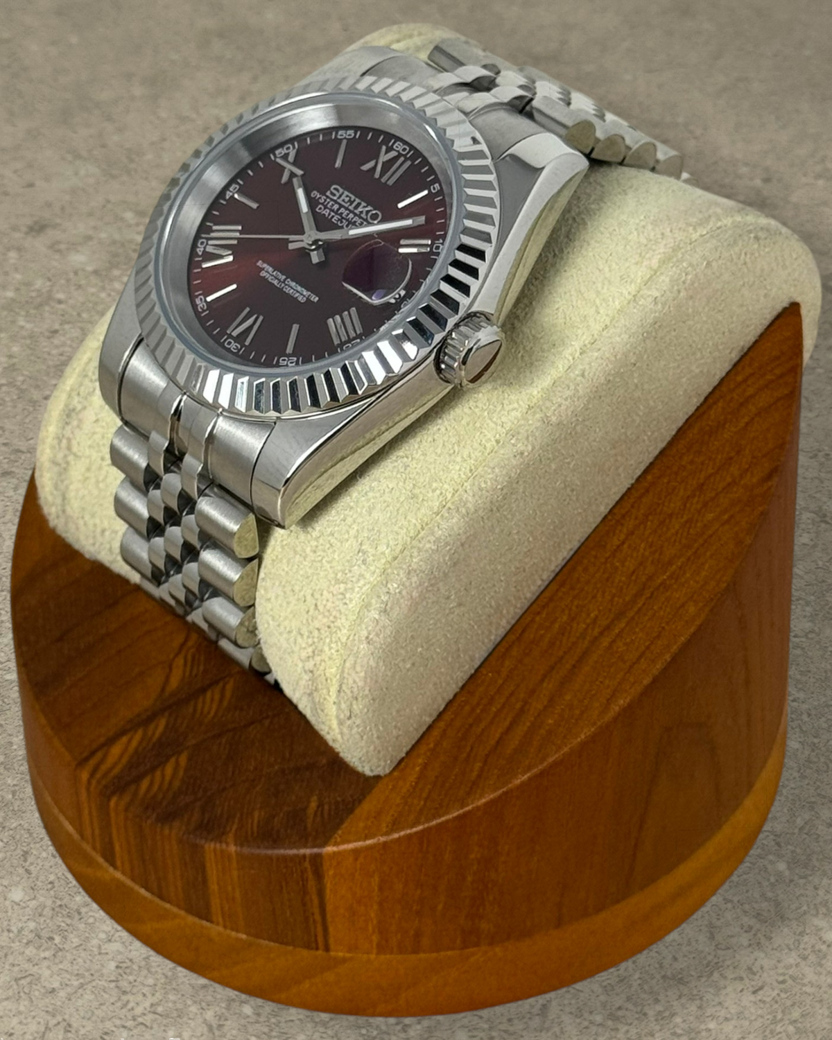 PB TimePiece Classic Date watch with chocolate dial, Roman numerals, fluted bezel, and stainless steel jubilee bracelet