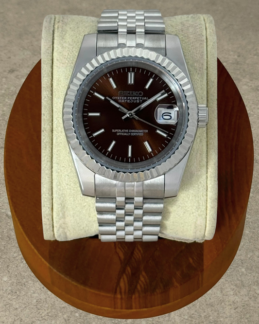 PB TimePiece Classic Date watch with a chocolate dial, stainless steel jubilee bracelet, and fluted bezel.