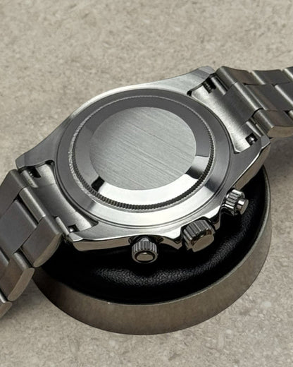 PB TimePiece chronograph watch showing the brushed stainless steel case back and polished oyster bracelet links.