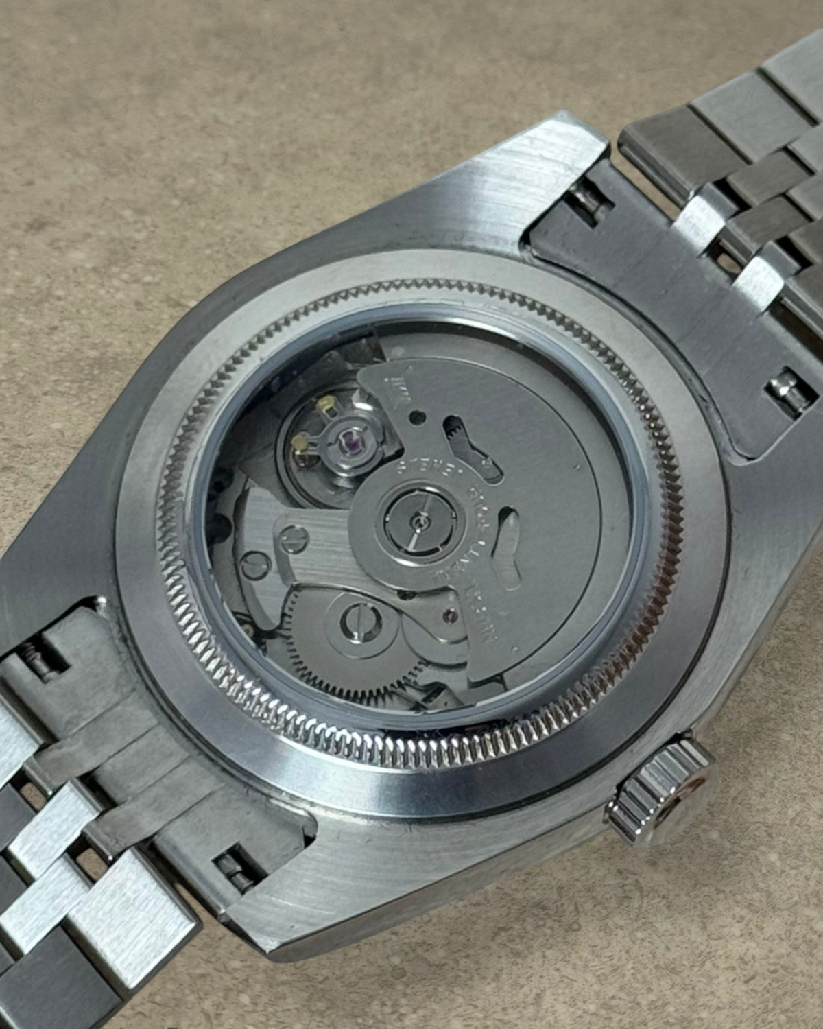 PB TimePiece Classic Date watch showing the exhibition case back with Seiko NH35 automatic movement and steel bracelet