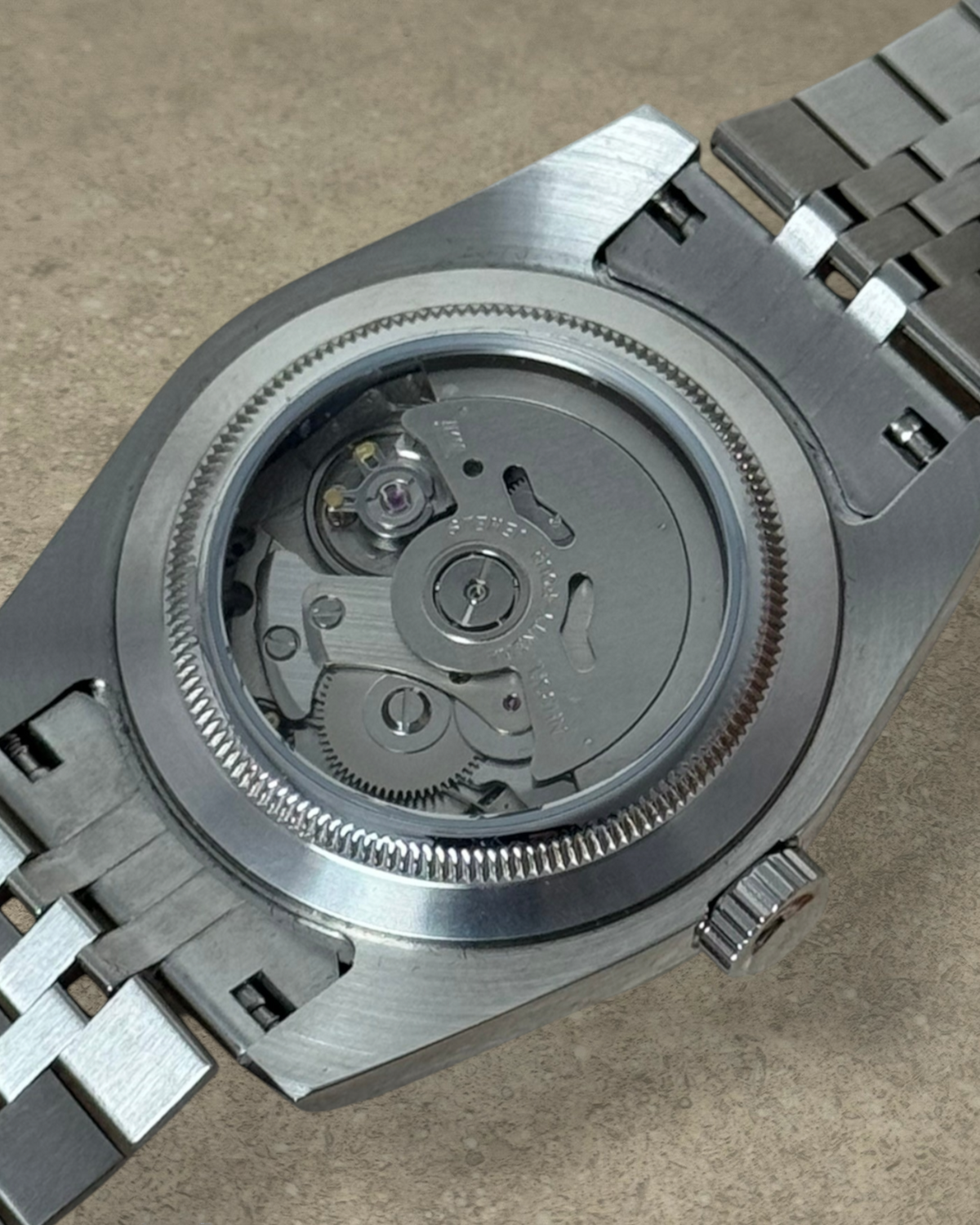 PB TimePiece Classic Date watch showing the stainless steel exhibition case back and jubilee bracelet movement