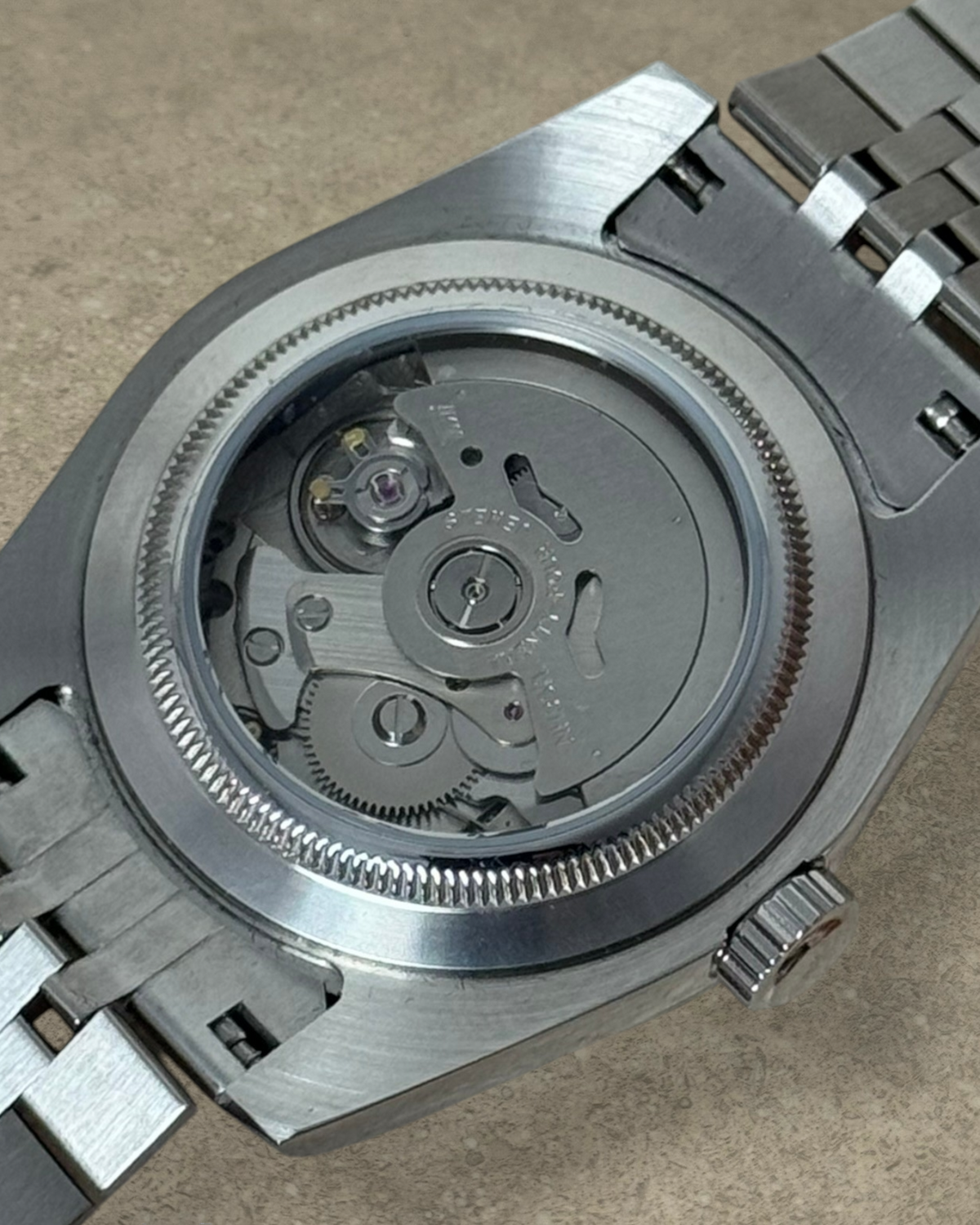 PB TimePiece Classic Date watch showing the exhibition case back with Seiko NH35 automatic movement and steel bracelet
