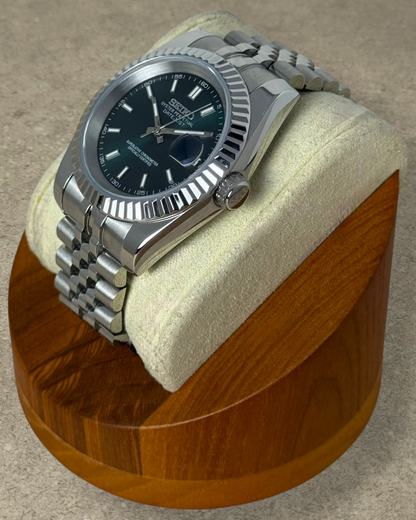 PB TimePiece Classic Date watch with a forest green dial, fluted bezel, and stainless steel jubilee bracelet.