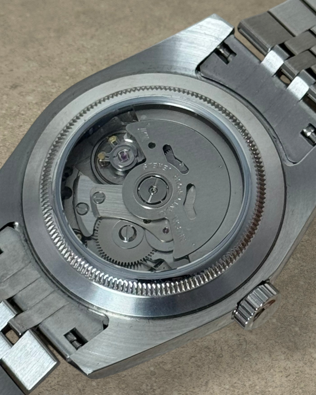 PB TimePiece Classic Date watch showing the stainless steel case back and automatic Seiko NH35 movement