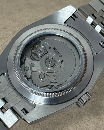 PB TimePiece Classic Date watch showing the stainless steel case back and automatic Seiko NH35 movement