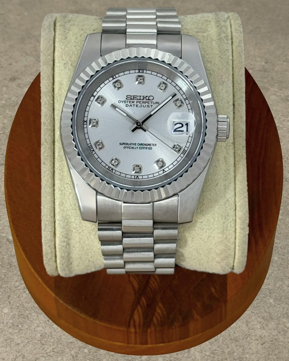 PB TimePiece Classic Date watch with silver dial, crystal markers, fluted bezel, and stainless steel bracelet.