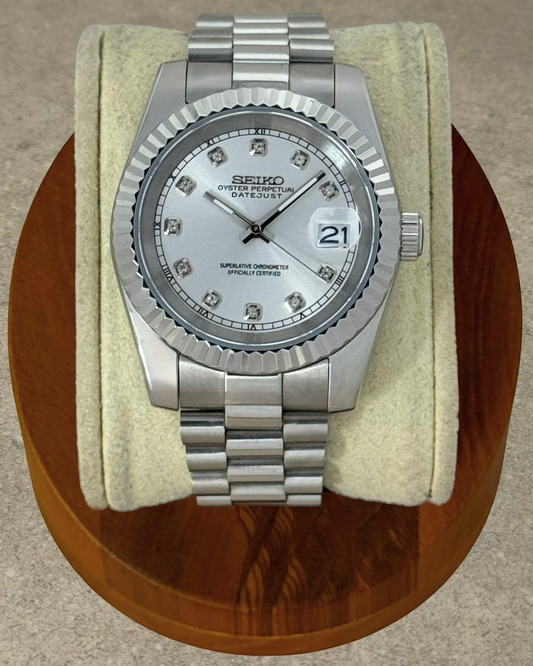 PB TimePiece Classic Date watch with silver dial, crystal markers, fluted bezel, and stainless steel bracelet.