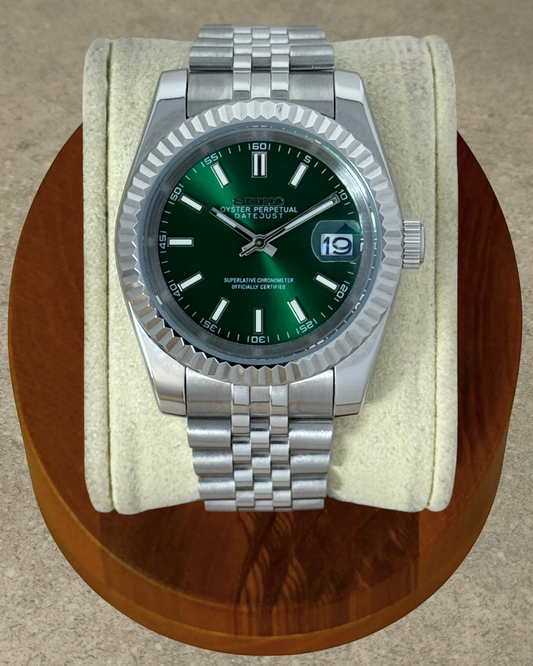 PB TimePiece Classic Date watch with emerald green dial, fluted bezel, and stainless steel jubilee bracelet.