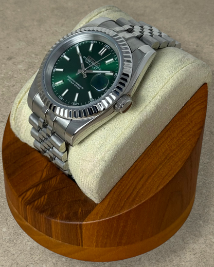 PB TimePiece Classic Date watch with emerald green dial, stainless steel jubilee bracelet, and fluted bezel.