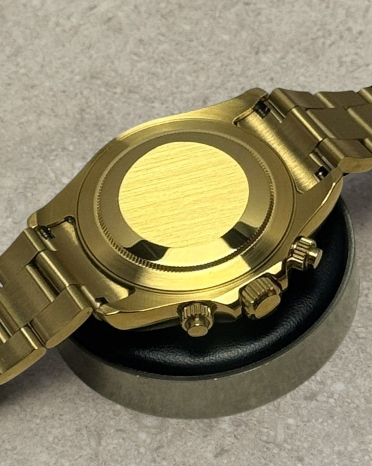 PB TimePiece John Mayer chronograph watch showing the polished gold case back and oyster bracelet