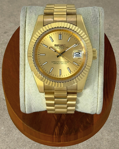 PB TimePiece Classic Date watch with gold stainless steel case, fluted bezel, champagne dial, and presidential band.