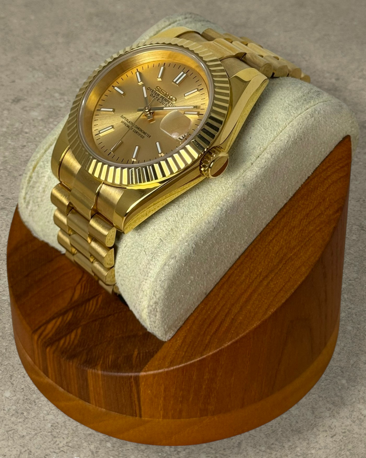 PB TimePiece Classic Date gold stainless steel watch with champagne dial, fluted bezel, and presidential bracelet.