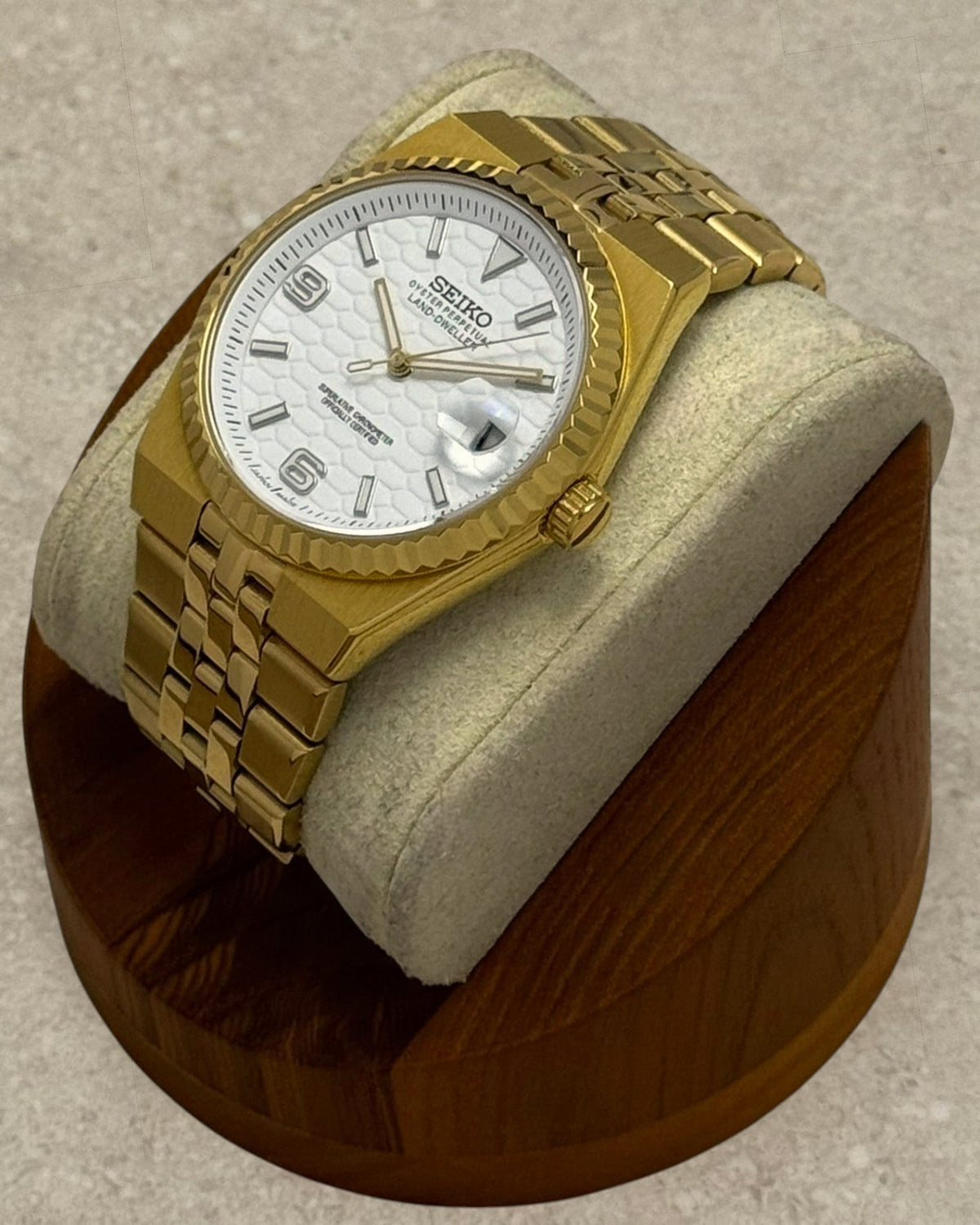 PB TimePiece Honeycomb watch with a gold case, fluted bezel, jubilee bracelet, and white textured honeycomb dial.