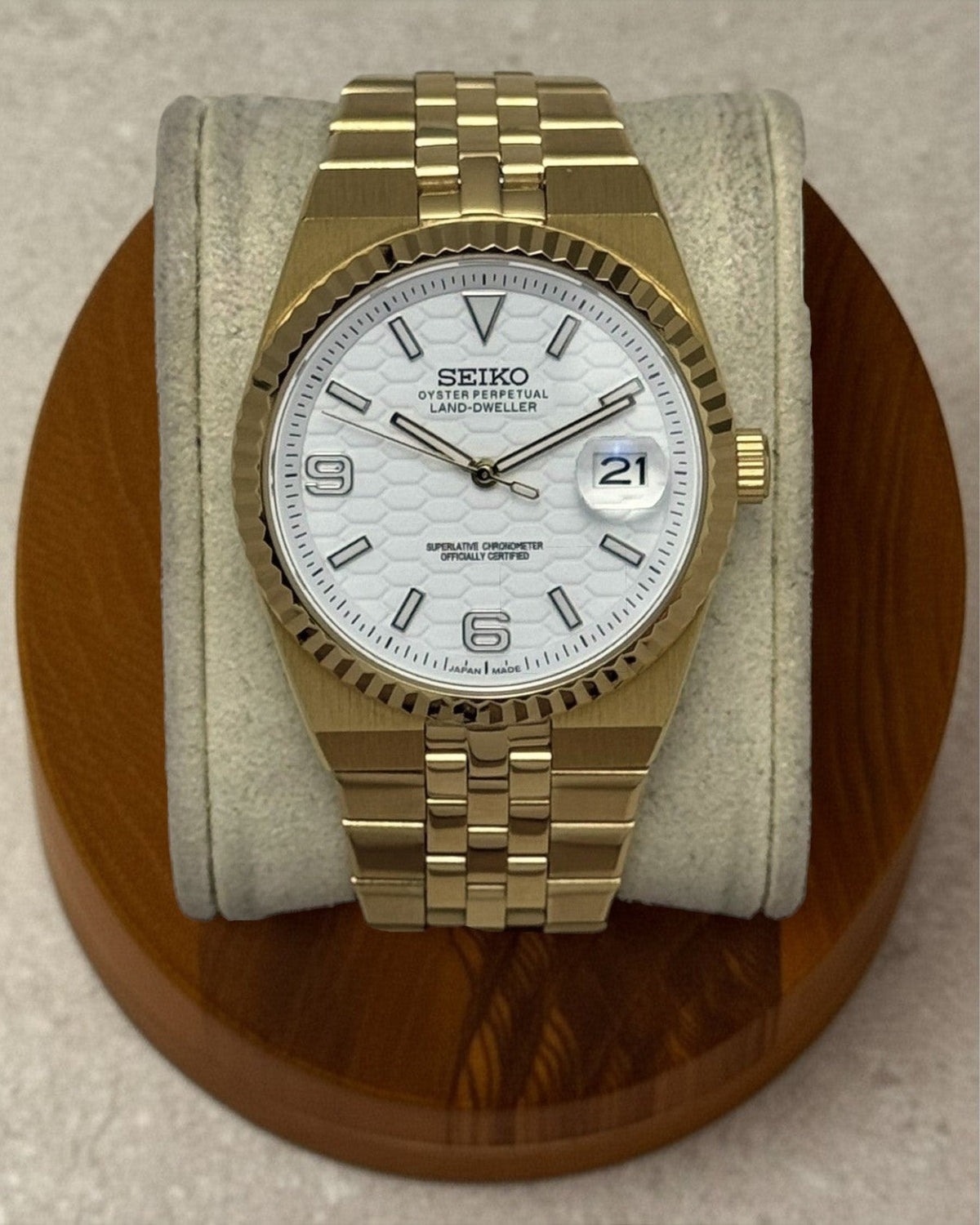 PB TimePiece Honeycomb gold watch with a white textured dial, fluted bezel, and gold jubilee bracelet.