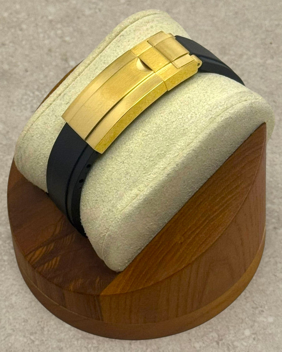 PB TimePiece Yachtmaster watch featuring a gold micro-adjusting clasp and black rubber strap on a wooden display stand