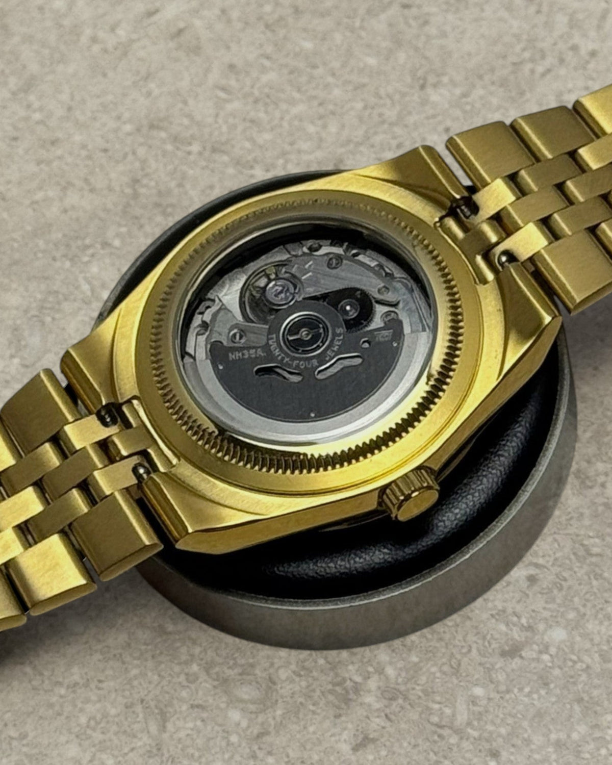 PB TimePiece Honeycomb watch showing the gold case back and exhibition window revealing the Seiko NH35 movement