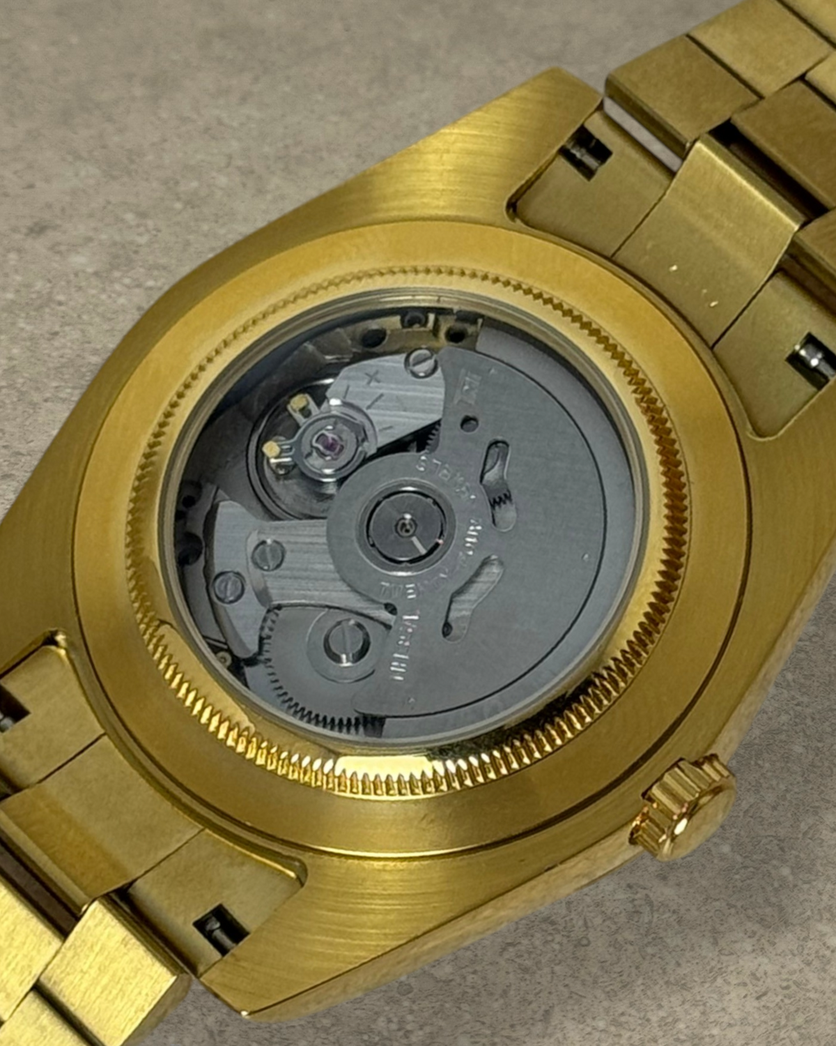 PB TimePiece Classic Date gold watch showing the exhibition case back with Seiko NH35 automatic movement