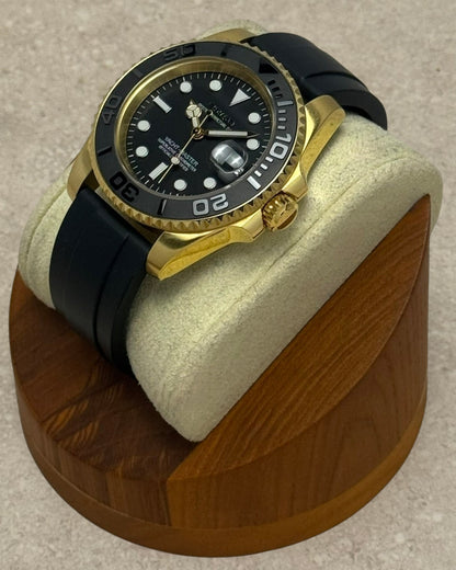 PB TimePiece Yachtmaster watch with gold stainless steel case, black rubber strap, and rotating matte black bezel.