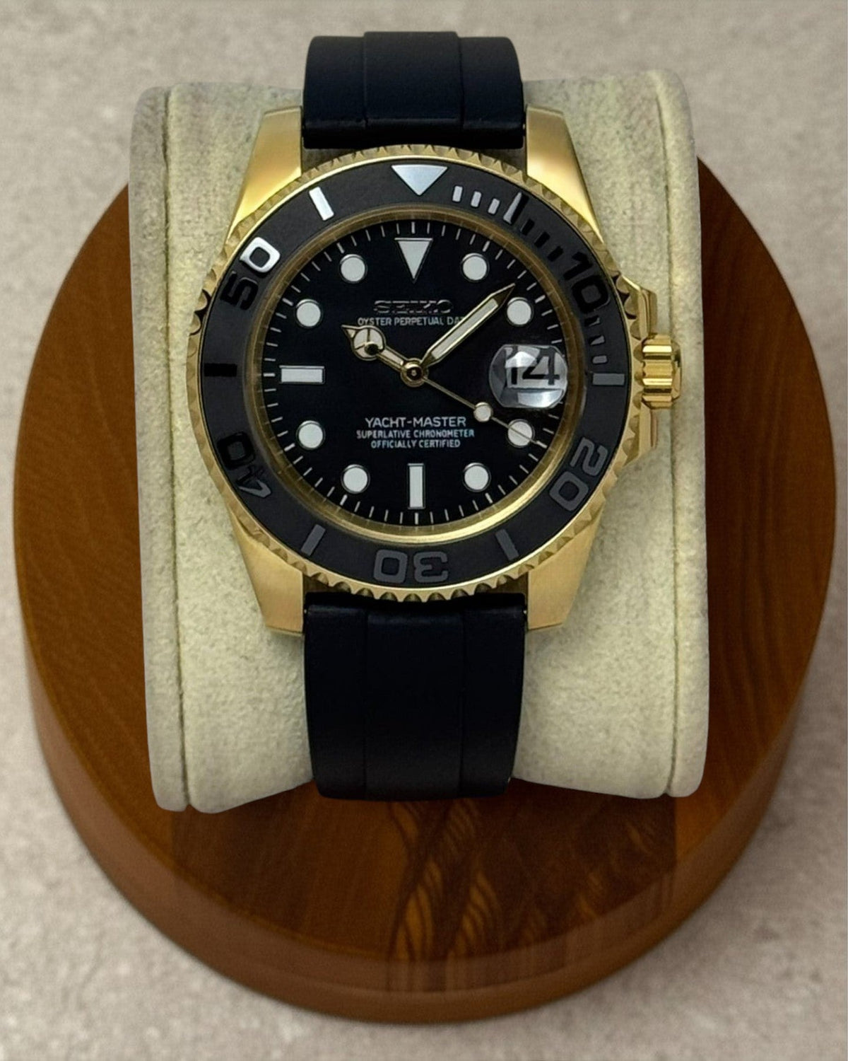 PB TimePiece Yachtmaster watch with a gold stainless steel case, black dial, gold hands, and black rubber strap.