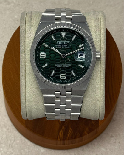 PB TimePiece Honeycomb watch with a forest green textured dial, stainless steel case, and jubilee bracelet.