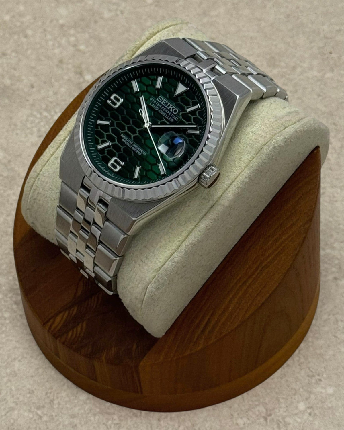 PB TimePiece Honeycomb watch with a forest green textured dial, stainless steel jubilee bracelet, and fluted bezel.